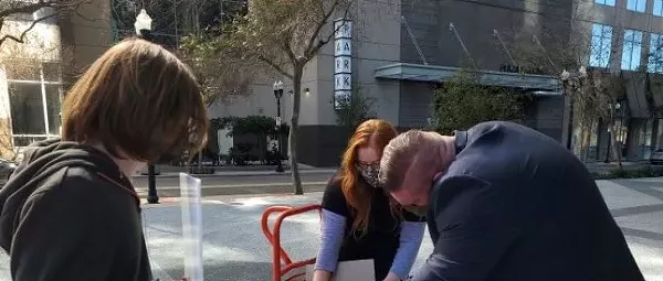 Activists deliver thousands of 'past due' $2,000 invoices to Marco Rubio's Orlando office