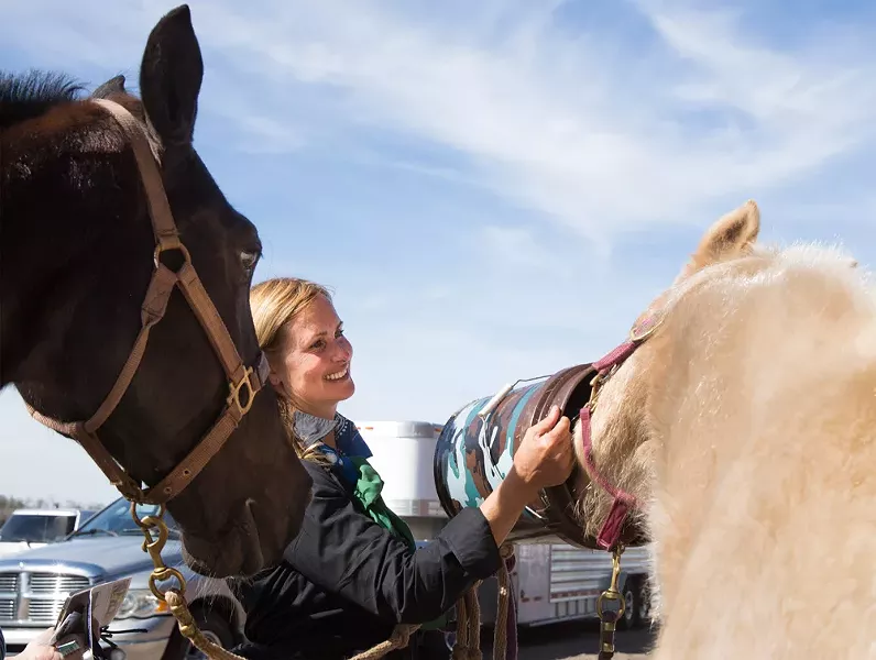 Lori Wilfcord-Herbenick, of Jacksonville, - waters her daughter’s horse Flicka after the drive.