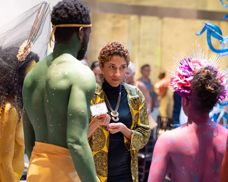 Artist and poet YaYa Delvalle, who exhibited her work at the 1st Thursdays event, shares an exchange with the Rainbow Myriads. - PHOTO BY MATT KELLER LEHMAN