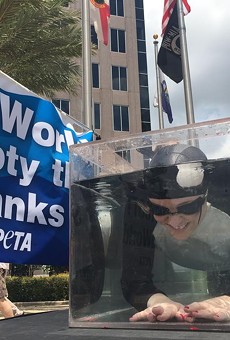 PETA protests SeaWorld in downtown Orlando by putting orca-woman in tiny water tank