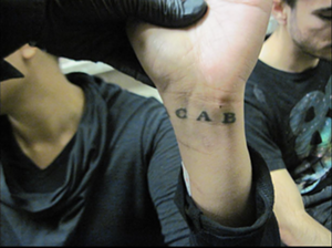 A photo of an arrested protester's "ACAB" tattoo. Prosecutors cited the tattoos as evidence that the demonstrators were in a gang. - PHOTO VIA MCAO