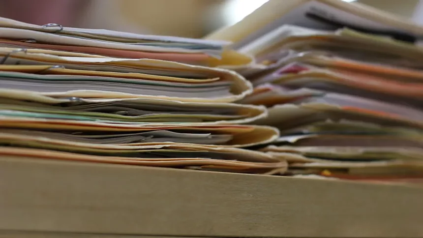 The case files of unidentified homicide victims stack up at the Maricopa County Medical Examiner's Office. - SEAN HOLSTEGE