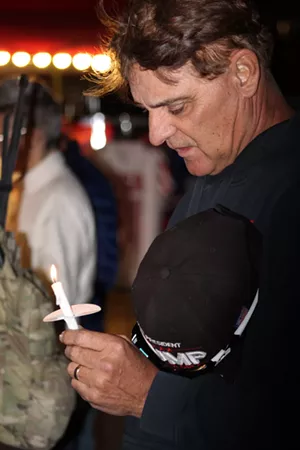 One demonstrator at the January 6 vigil in Phoenix bows his head during prayers for those killed during the U.S. Capitol riot and fellow protestors who are in prison. - ELIAS WEISS