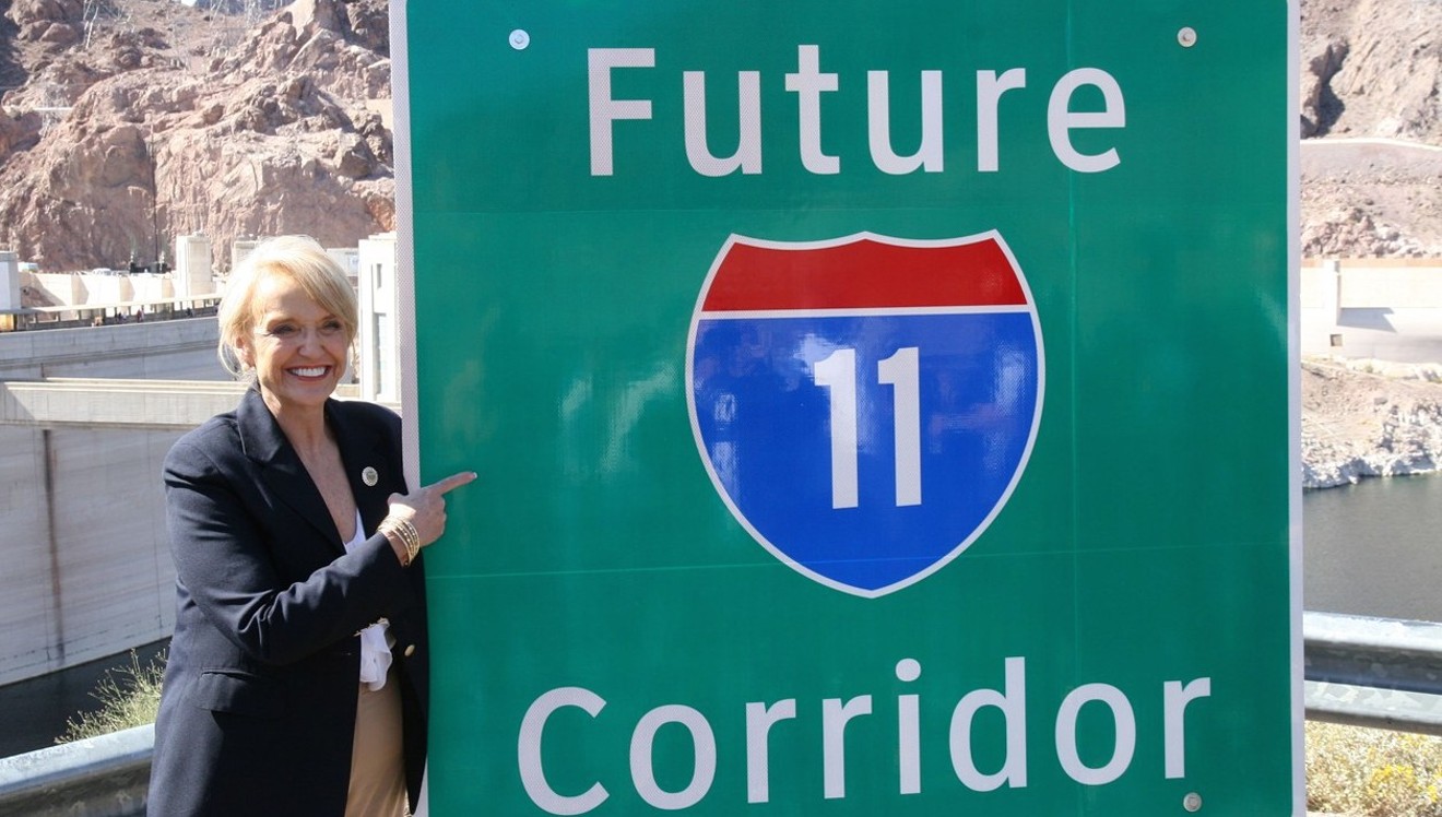 Former Governor Jan Brewer unveils new signs at a March 2014 ceremony at Hoover Dam, after Congress designated the future Interstate 11 route.