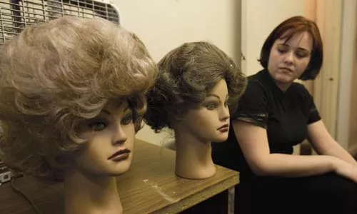 Actor Jessica Kennedy eyes wigs for her dual role as Myra/Myrna in Open Stage Theatre's production of The Mineola Twins. - HEATHER MULL