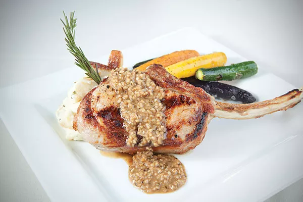 Bone-in veal chop, rosemary-and-garlic mashed potatoes and roasted tricolored carrots and zucchini - PHOTO BY HEATHER MULL
