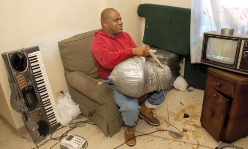 Dorsey, in his Hill District apartment, checks the cord on his customized blender.