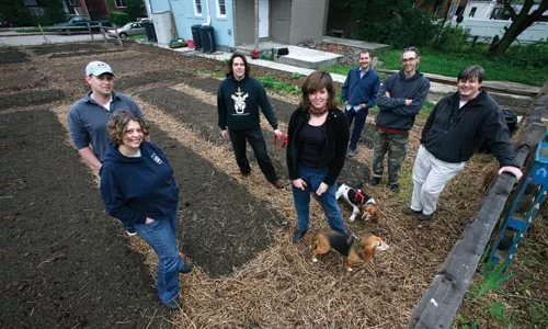 Enright Garden volunteers (from left): Tait Tomb; Kim Wynnyckyj, of Whole Foods; Dan Allen; Sallyann Kluz, with beagles Pearl and Fred; Mikal Merlina; Matt Miller; and Casey Dill, of Whole Foods - HEATHER MULL