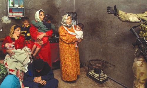 Facing Conflict: Chris Hondros' "Iraqi Family Looking at Soldier" (2003)