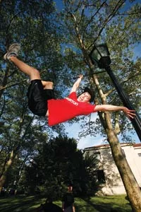 Flag day: Alex Rodia does Gene Kelly one better on a lamppost. - HEATHER MULL