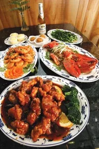General Tsao's chicken (front), salt-and-pepper shrimp (left) and lobster with ginger-scallion sauce (right) - HEATHER MULL