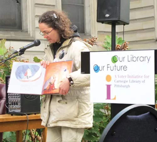 Megan Fogt "reads to the people" at the Carnegie Library, in Oakland. - PHOTO BY CHRIS YOUNG