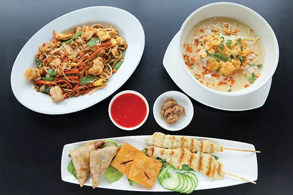 Nyat khaukswe kyaw noodles with shrimp; chicken noodle soup with coconut; and appetizer sampler: samosas, crispy tofu squares and chicken satay - PHOTO BY HEATHER MULL