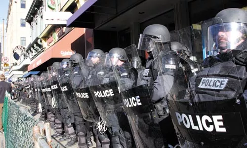 Police officers in riot gear met protesters at a 2006 anti-war march. More of the same is expected at September's G20 summit. - RENEE ROSENSTEEL