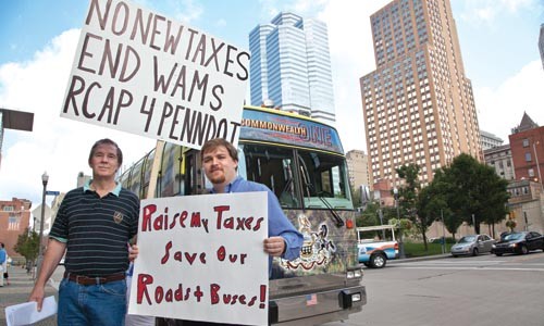 Raise taxes or cut transit; Gary English, left, and Cullen Vandora, (pictured at a recent transit protest) aren't the only two people taking sides. - JOHN ALTDORFER