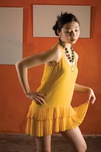 Siran wears: gold silk dress by Twelfth Street by Cynthia Vincent, available at Chick Downtown; quartz, wood and crystal necklace, by local designer Alma Lleros-Thompson for Alma Jewelry, available at Mia Boutique. - HEATHER MULL