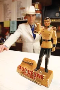 Slim Forsythe points out a strong resemblance between the "Prince of Pilsener," depicted in this statue and his father, Frank Forsythe (below, left, on the set of KDKA-TV's Duquesne Showtime).