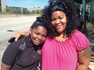 Tamara Gibson, 42, was taking her daughter, Avani, 9, to the hair salon from the Negley Station. She said she is happy with the new machines and ConnectCards. - PHOTO BY EMILY DEMARCO/PUBLICSOURCE