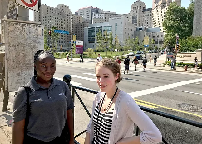 UPMC employees Ashley Smith (left) and Ellie Lalonde (right) in front of UPMC Presbyterian in Oakland - CP PHOTO: RYAN DETO
