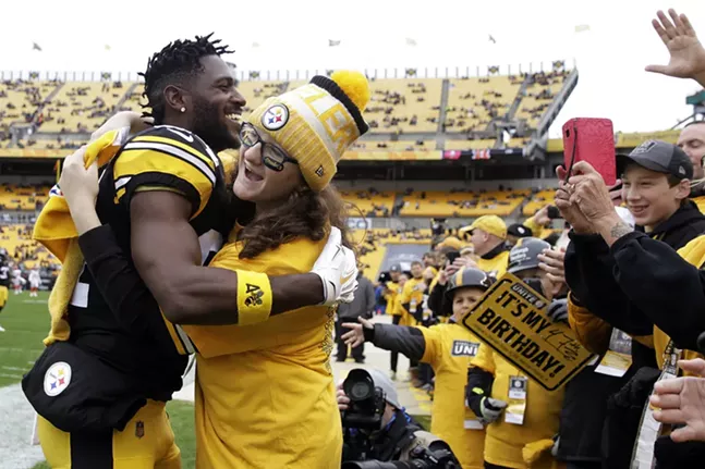 Antonio Brown hugs a fan on the sidelines prior to kickoff against the Cleveland Browns at Heinz Field. - CP PHOTO: JARED WICKERHAM