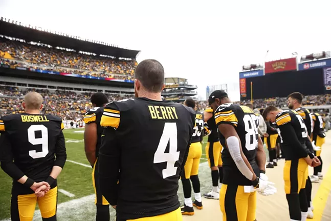 Jordan Berry and his teammates observe a moment of silence for the victims of the mass shooting at Tree of Life Synagogue. - CP PHOTO: JARED WICKERHAM