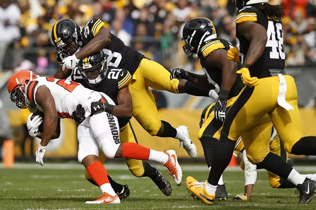 Duke Johnson #29 of the Cleveland Browns is gang tackled by Sean Davis #21 and Mike Hilton #28 of the Steelers. - CP PHOTO: JARED WICKERHAM