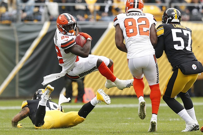 Jabrill Peppers #22 of the Cleveland Browns is upended on a punt return by Roosevelt Nix-Jones #45. - CP PHOTO: JARED WICKERHAM