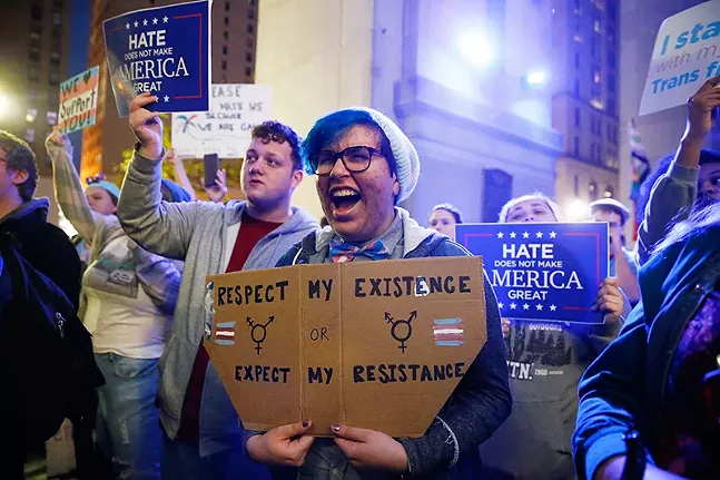 "Respect my existence": People hold up messages in support for transgender rights during a Trans-Rights Rally in Downtown Pittsburgh on Thu., Nov. 2. - CP PHOTO: JARED WICKERHAM