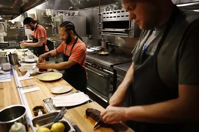 Sous chef Jeff Green (middle) prepares house-made Bistec A La Plancha at Morcilla - CP PHOTO: JARED WICKERHAM
