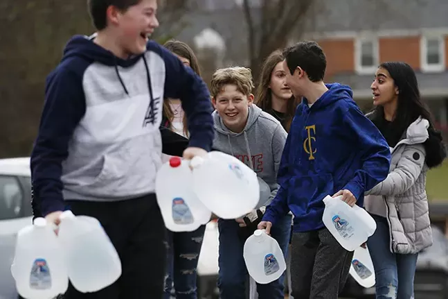 Shadyside Academy eighth grader Parker Mendham, 13, helps his classmates load up water into a car during a 412 Food Rescue - CP PHOTO: JARED WICKERHAM