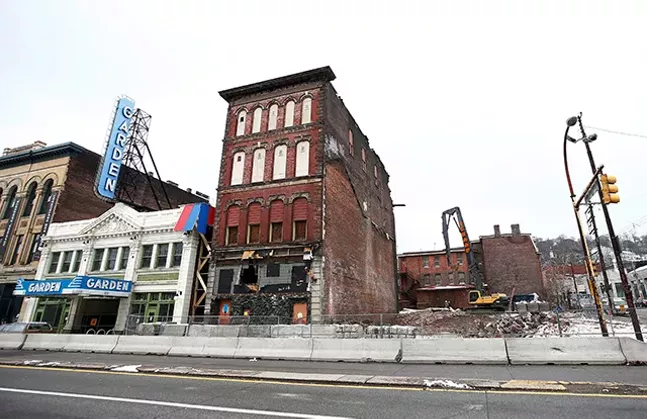 Condemned buildings are torn down next to the Garden Theater on the North Side. - CP PHOTO: JARED WICKERHAM