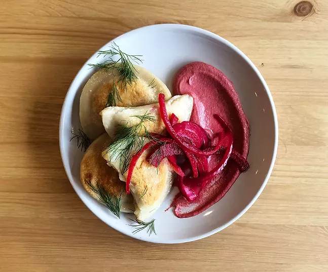 Pierogi, stuffed with potato and caramelized onion and served with pickled veg and beet crema - PHOTO: ABBIGAIL HANSEL, HEAD DINNER CHEF