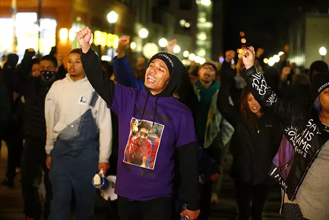 Khalil Darden, 18, of Penn Hills, leads a group of protesters through East Liberty on Fri., March 22 - CP PHOTO: JARED WICKERHAM