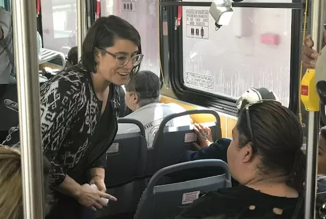 Sara Innamorato talking to a bus rider during her transit town hall on the 91 bus - CP PHOTO: RYAN DETO