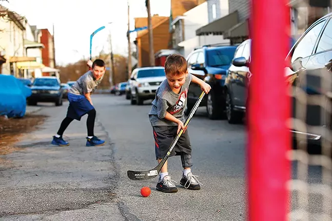 Brady Malcom and Liam Collins play hockey with their dad Chris in Bloomfield. - CP PHOTO: JARED WICKERHAM
