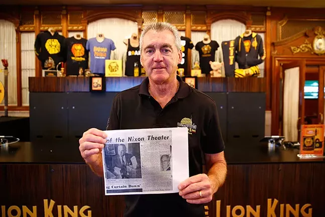 Pat Lohrer holds up a photo of his great grandfather John Barnhart in The Benedum Center’s lobby - CP PHOTO: JARED WICKERHAM