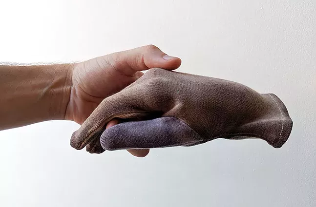 Adam Milner holds a glove stained with his boyfriend's blood from "Taking good care of your things leads to taking good care of yourself" - CP PHOTO: LISA CUNNINGHAM