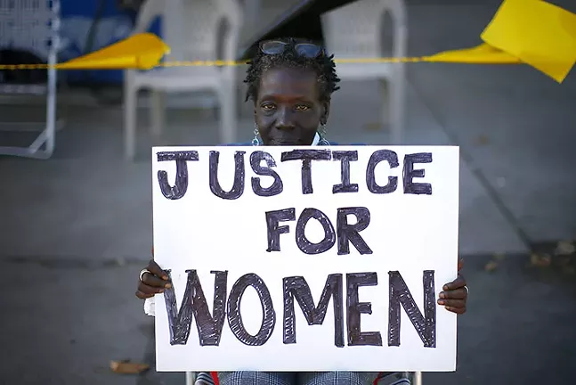 Vanetta Olds protests the alleged assault of two Black women customers at the Exxon Mobile gas station near Marshall-Shadeland on Thu., Sept. 26. - CP PHOTO: JARED WICKERHAM