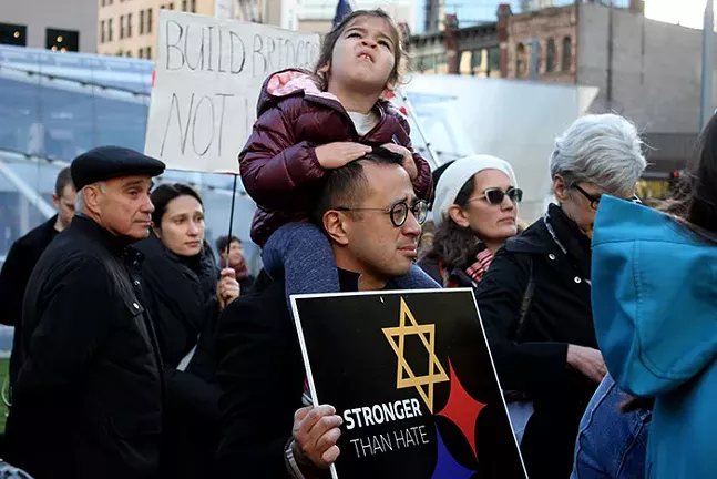 Nathaniel Yap and his daughter participate in Pittsburgh's Bend the Arc's rally - CP PHOTO: JOIE KNOUSE