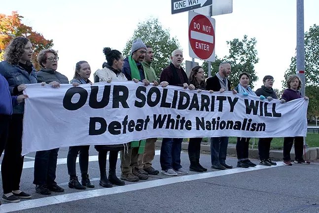 Protesters prepare to sit at the intersection of Commonwealth Place and Liberty Avenue as part of a peaceful protest - CP PHOTO: JOIE KNOUSE