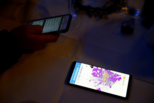 Cell phones with the latest poll results lay on tables throughout the election party. - CP PHOTO: JARED WICKERHAM