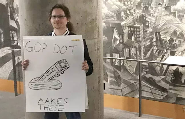 A student protests outside Elaine Chao's appearance at Carnegie Mellon University. - CP PHOTO: RYAN DETO