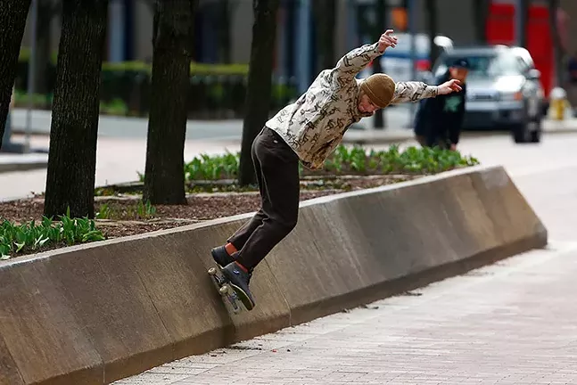 A skateboarder on a mostly empty Grant Street in Downtown Pittsburgh on Sun., March 15 - CP PHOTO: JARED WICKERHAM