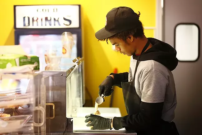 Galen Moorer, Jr., owner of Happy Day Dessert Factory, puts together an ice cream order for a customer in the North Side on Sun., March 22. - CP PHOTO: JARED WICKERHAM