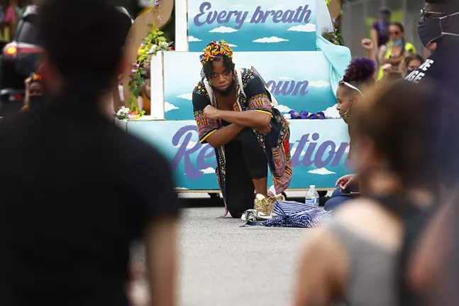 State Representative Summer Lee kneels during a moment of silence lasting 8 minutes and 46 seconds. - CP PHOTO: JARED WICKERHAM
