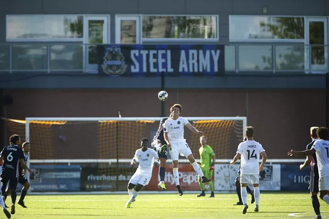 An empty balcony and standing-room only section sit empty as Mark Forrest #16 of the Pittsburgh Riverhounds goes up for a header against Indy Eleven. - CP PHOTO: JARED WICKERHAM