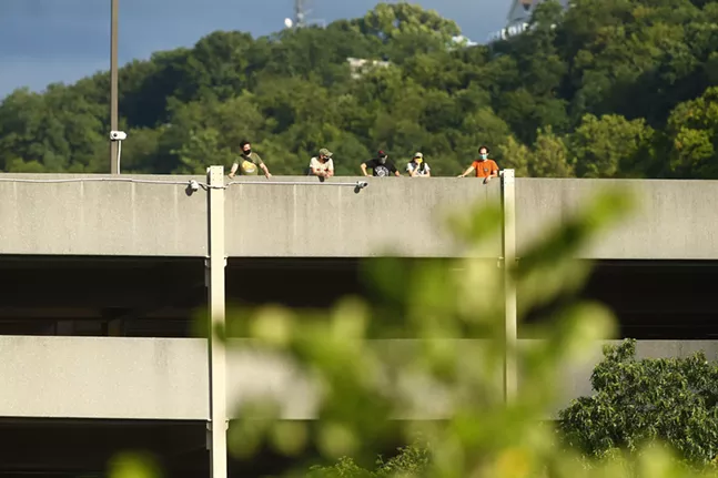 A group of Pittsburgh Riverhounds supporters watch the match from a nearby parking garage. - CP PHOTO: JARED WICKERHAM