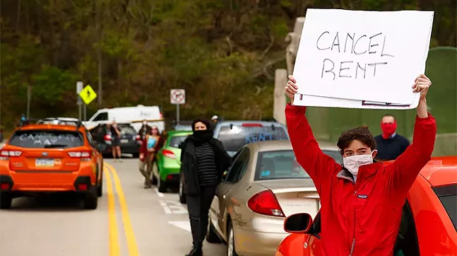 Protest demanding a rent and mortgage freeze amid the COVID-19 pandemic on the Greenfield Bridge in Pittsburgh on May 1, 2020 - CP PHOTO: JARED WICKERHAM
