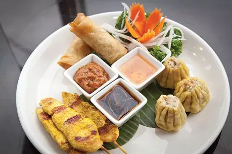 Appetizer sampler with steamed dumplings, chicken satay and shrimp spring rolls - PHOTO BY HEATHER MULL