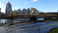 Groups laid an 8,000-square-foot tarp on Allegheny Landing on the North Side to protest ALCOSAN's proposed construction along the region's river fronts. - PHOTO BY ASHLEY MURRAY